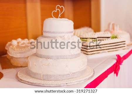 A multi level white wedding cake laid on a table