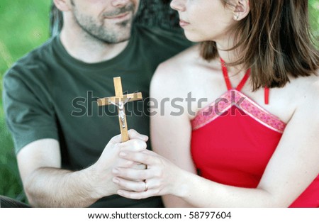 Christian couple is praying in the nature.