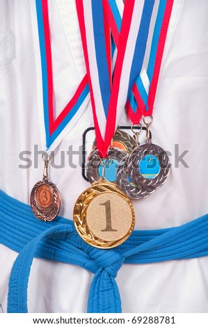 attractive teenage boy wearing winning medal around his neck