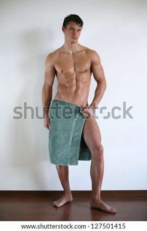 Wet muscular man wrapped in a towel