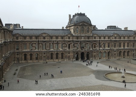 PARIS, FRANCE - JANUARY 5, 2013: People walk in front of the Renaissance wing of the Louvre Museum in Paris, France.
