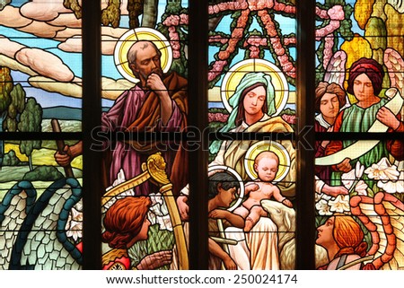KUTNA HORA, CZECH REPUBLIC - AUGUST 23, 2014: The Holy Family, an Art Nouveau stained glass window in Saint Barbara Church in Kutna Hora, Czech Republic.