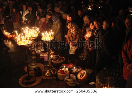 PRAGUE, CZECH REPUBLIC - MAY 5, 2013: Orthodox believers pray during an Orthodox Easter night service in front of the Dormition Church at the Olsany Cemetery in Prague, Czech Republic.