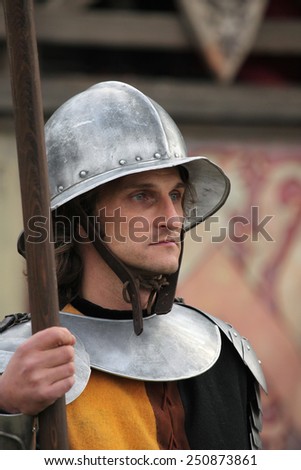 MILOVICE, CZECH REPUBLIC - OCTOBER 23, 2013: Background actor dressed as a medieval guard attends the filming of the new movie The Knights directed by Carsten Gutschmidt near Milovice, Czech Republic.