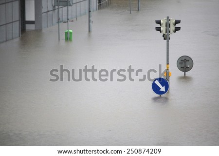 PRAGUE, CZECH REPUBLIC - JUNE 3, 2013: Flooded crossroad with traffic lights and a keep right traffic sign partially flooded by the swollen Vltava River in Prague, Czech Republic.