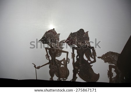 YOGYAKARTA, INDONESIA - AUGUST 13, 2012: Traditional Indonesian shadow puppet theatre wayang kulit performs on street during a religious festival in Yogyakarta, Central Java, Indonesia.