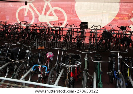 AMSTERDAM, NETHERLANDS - AUGUST 9, 2012: Colourful bicycles parked at the bicycle parking station next to the Central railway station in Amsterdam, Netherlands.