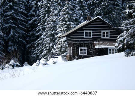 Snow-covered ski resort house in the snow-covered firry forest in the Czech mountains