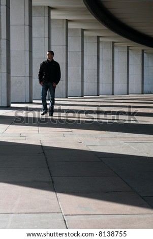 Young man walking on the colonnade