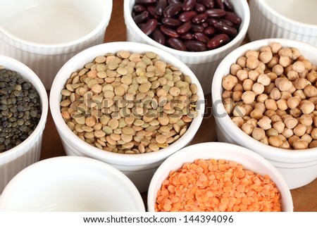 Bowls with different kinds of lentil, beans and chickpea.
