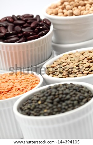 Bowls with different kinds of lentil, beans and chickpea.