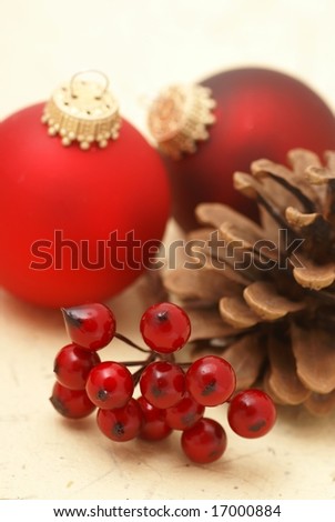 Christmas ornaments, berry and cone. Focus on berries, shallow DOF.