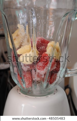 Frozen fruit in a blender ready to blend