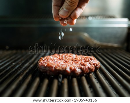 Similar – Image, Stock Photo Chef preparing burgers at grill plate on international urban street food festival.