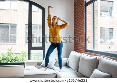 Image, Stock Photo Cheerful women dancing while listening to music
