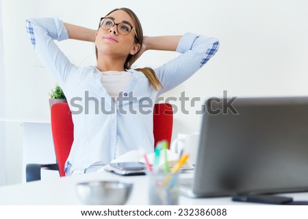 Portrait of pretty young woman relaxing one moment in her office.