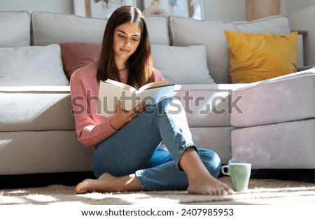 Similar – Image, Stock Photo Woman reading a book in cafe sitting at wooden table with flowers in a vase. Romantic date with a book. Brown vintage neutral color background. Literature & Library, book lover spending leisure time.