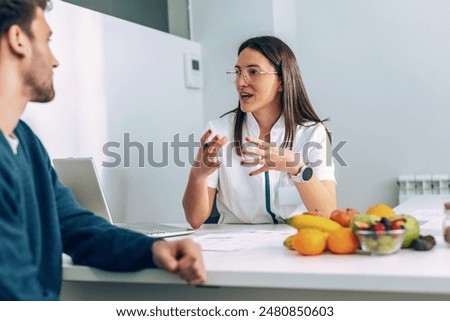 Similar – Image, Stock Photo Fitness woman consulting her training on her smartphone sitting in a jump box in the gym