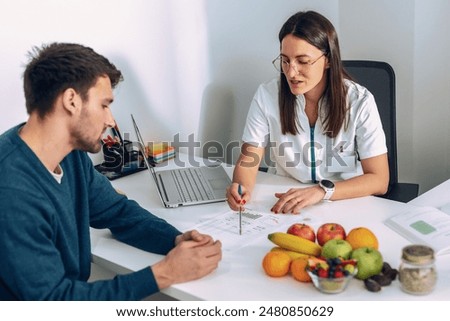 Image, Stock Photo Fitness woman consulting her training on her smartphone sitting in a jump box in the gym