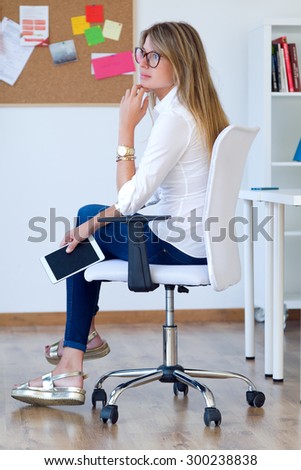 Portrait of business young woman relaxing one moment in her office.