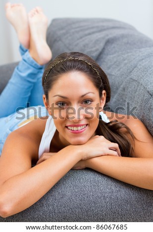 beautiful woman lying on the couch at home