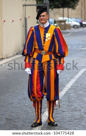 VATICAN CITY, ITALY - APRIL 22: A Papal Swiss Guard stands guard at the entrance of Saint Peter\'s Basilica on April 22, 2012. Swiss Guards in their traditional uniform.