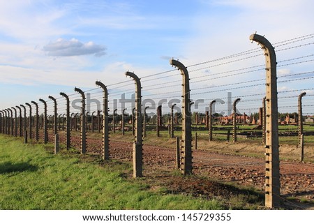 OSWIECIM, POLAND - JULY 23: Barbed wire electrical fence at Auschwitz Birkenau concentration camp on July 23, 2011 in Oswiecim, Poland.  It was the biggest nazi concentration camp in Europe