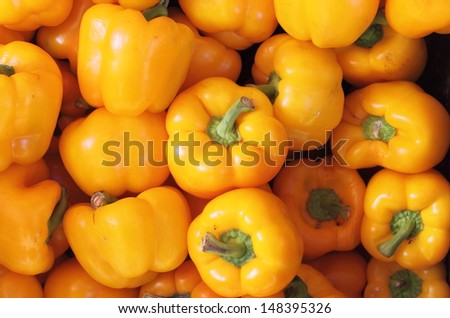 Bunch of yellow peppers for sale in a greengrocery