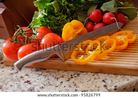 Cut up pepper on a cutting board with other vegetables