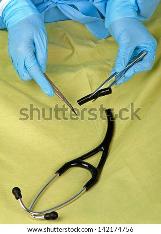 A surgeon dissects a stethoscope in order to cut costs.