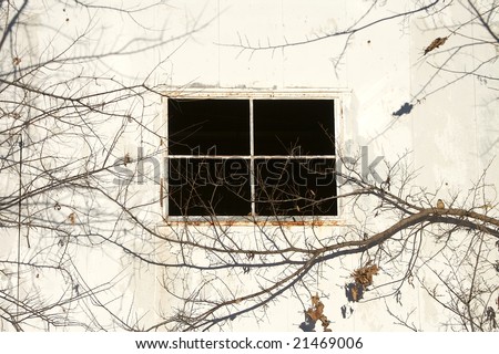 Photograph of a empty black window of a trailer.