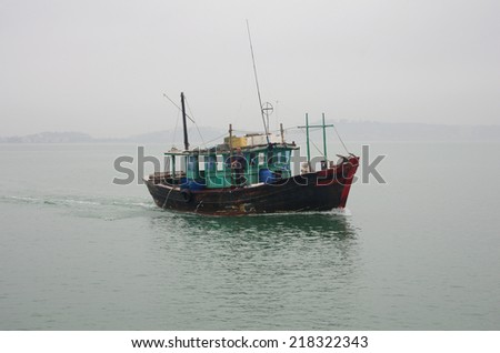 HALONG - FEBRUARY 28: Fishing boat in Halong Bay on February 28, 2013 HALONG, VIETNAM. Halong Bay is a UNESCO World Heritage Site and it is one of the prime travel destinations in Vietnam