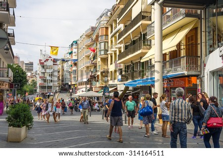 BENIDORM, SPAIN - OCTOBER 06, 2014: People walking on the shopping street of Mediterranean resort Benidorm, province of Alicante, Spain