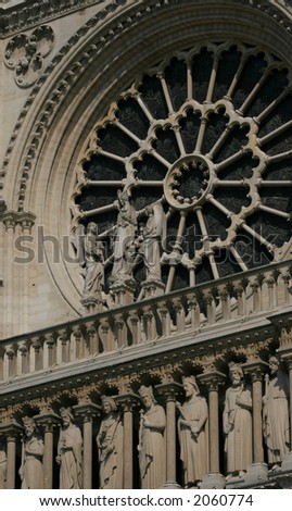 Detail of rose window and carved figures at Notre Dame Cathedral in Paris, France.