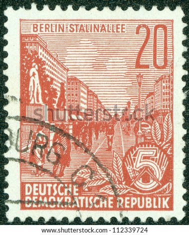 EAST GERMANY - 1953: A stamp printed in East Germany shows Stalin-Allee (also known as the Karl-Marx-Allee) in Berlin, series, circa 1953