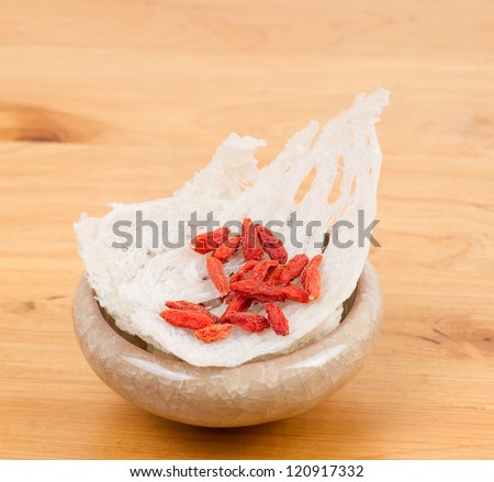 Edible bird's nest with chinese wolfberry fruit on table