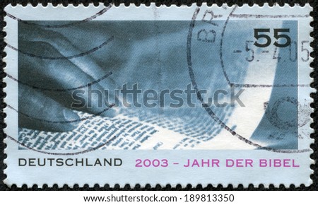 GERMANY - CIRCA 2003: A stamp printed in German Federal Republic issued for Year of the Bible, showsHand and Page, circa 2003