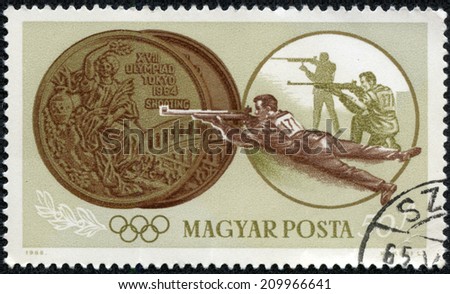HUNGARY - CIRCA 1965: stamp printed by Hungary, shows two medals, shooting, Summer Olympics in Tokyo, series, circa 1965