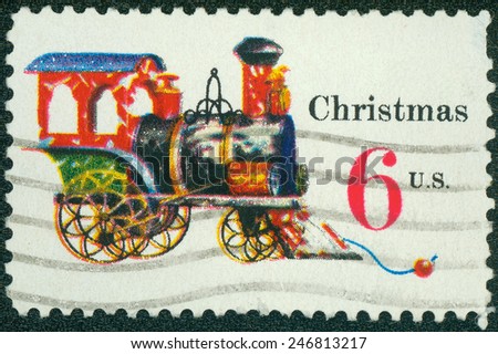 UNITED STATES OF AMERICA - CIRCA 1975: a stamp printed in the USA shows Tin and Cast-iron Locomotive, Toy, Christmas, circa 1975