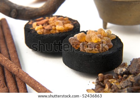 Various objects like incense sticks, granules and charcoal a holy ritual