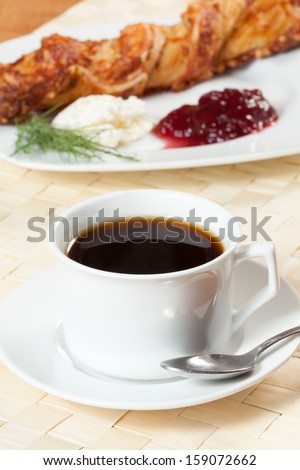 Light meal with coffee, bread and jam.