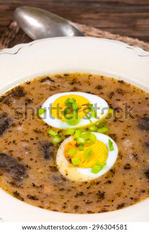 Traditional Polish soup with egg and smoked.