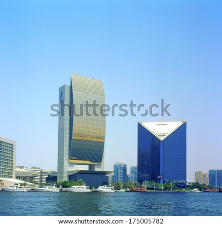 DUBAI, UAE - AUGUST 15: Modern architecture on the banks Dubai Creek on August 15, 2004. The creek is dividing the city into two main sections Deira and Bur Dubai and stands are many great buildings