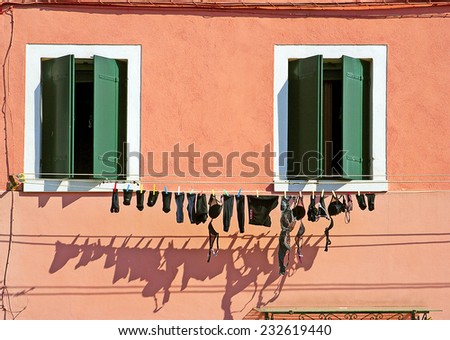 BURANO, ITALY - SEPTEMBER 1: Colorful houses on the famous island Burano on September 1, 2007 in Venice. Colorful houses and billowing underwear are typical signs of the Venetian island