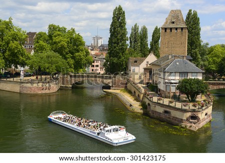 STRASBOURG, FRANCE - JULY 14, 2015: People Tourists viewing from a pleasure boats place called Petite-France in Strasbourg. Petite-France is an historic area in the center of Strasbourg, UNESCO WH