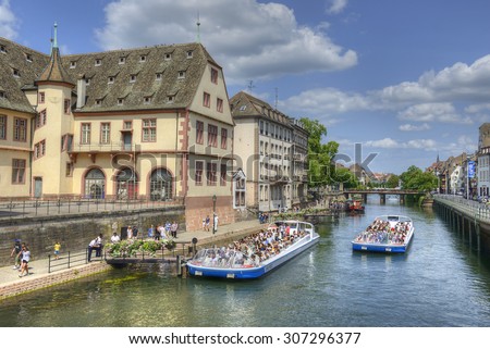 STRASBOURG, FRANCE - JULY 14, 2015: People Tourists viewing from a pleasure boats place in Strasbourg. The historic center of Strasbourg is UNESCO World Heritage Site