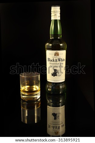 OSTRAVA, CZECH REPUBLIC - AUGUST 31, 2015: Black & White is a blended Scotch whisky . It was originally produced by the London-based James Buchanan & Co Ltd. Whisky Black and white on black background