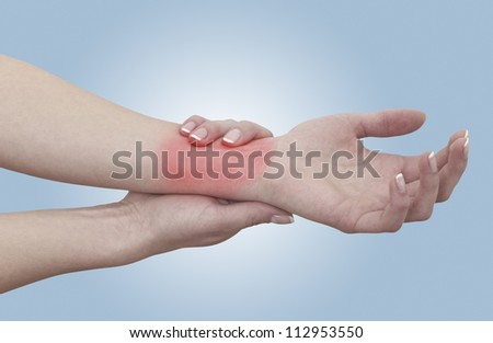 Acute pain in a woman wrist. Concept photo with blue skin with read spot indicating pain. Isolation on a white background