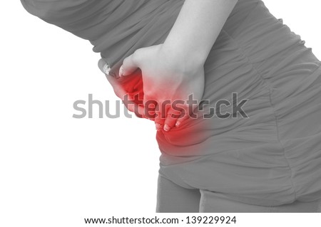Acute pain in a woman belly. Female holding hand to spot of belly-ache. Concept photo with Color Enhanced blue skin with read spot indicating location of the pain. Isolation on a white background.