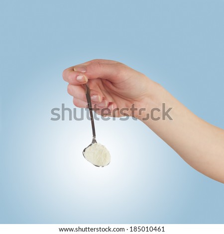 Powdered milk on spoon dairy food for baby. Isolated on white.